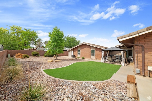 view of yard with a gazebo, a patio area, and central AC