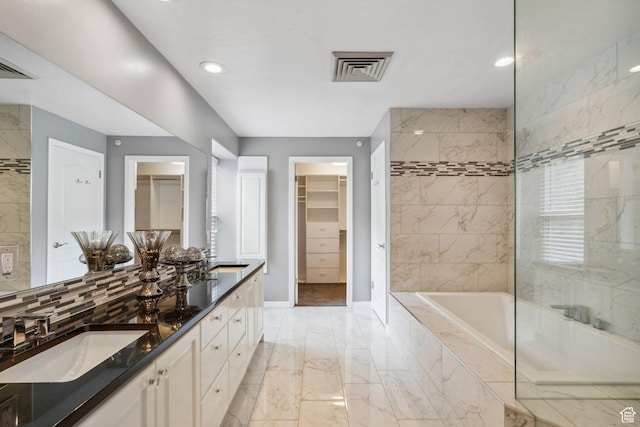 2863 S Cove Ln, Bountiful, UT 84010 - bathroom featuring marble finish floors, a relaxing tiled tub, baseboards, recessed lighting, and a spacious closet