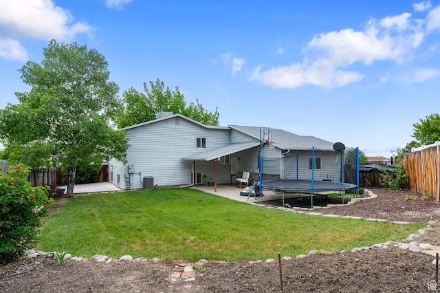 back of property featuring a patio, a trampoline, and central AC unit