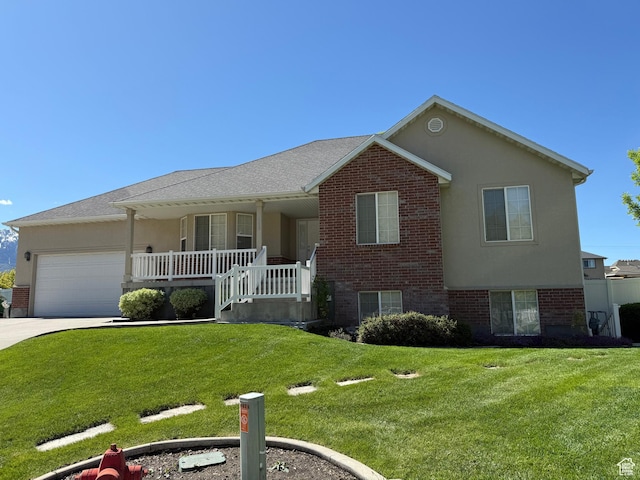 view of front of house featuring brick siding, a porch, a garage, and a front lawn