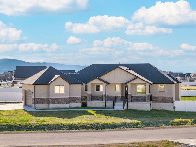 view of front of property with stone siding, a garage, driveway, and stucco siding