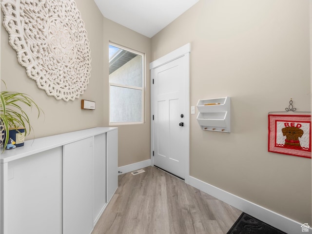 entryway featuring light wood finished floors and baseboards