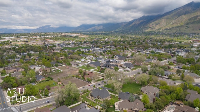view of property location featuring a mountain backdrop and nearby suburban area