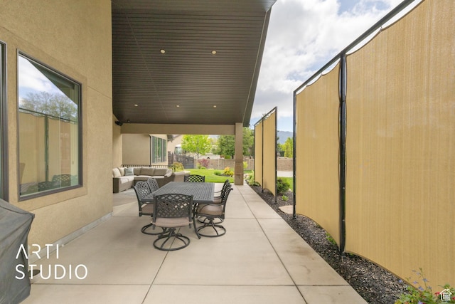 view of patio / terrace with an outdoor hangout area, fence, and outdoor dining space
