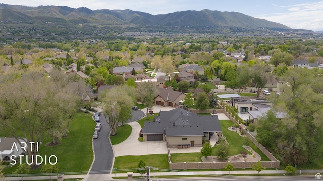 aerial view of property's location with mountains and nearby suburban area