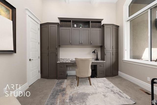 office featuring built in study area, carpet floors, and baseboards