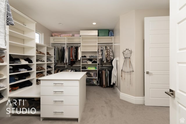 spacious closet featuring light colored carpet