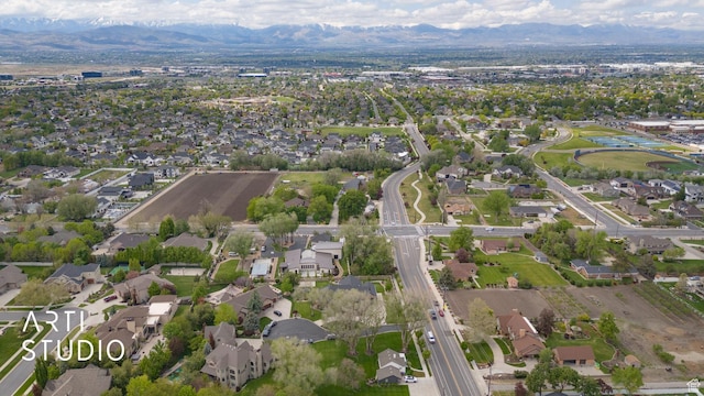 aerial view of property and surrounding area with mountains and nearby suburban area
