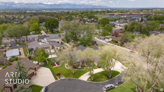aerial overview of property's location featuring nearby suburban area and a mountain backdrop