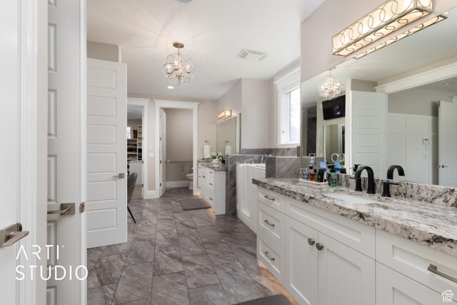 bathroom with a chandelier, marble look tile flooring, vanity, recessed lighting, and baseboards