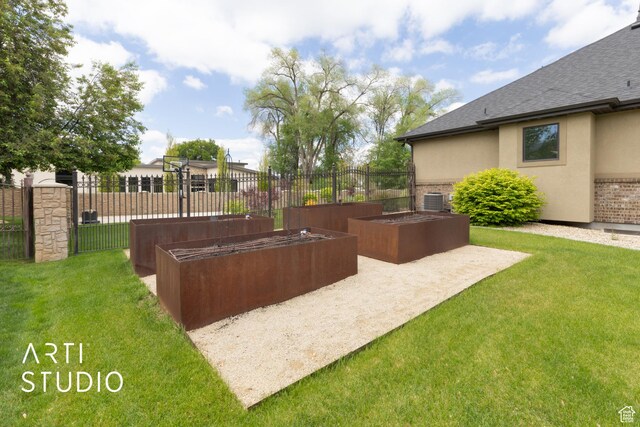 view of yard featuring a garden and central AC unit