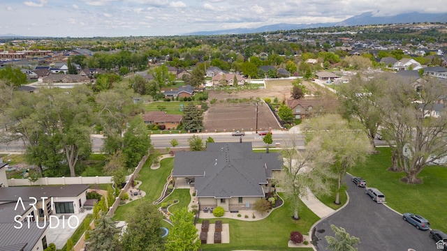 aerial overview of property's location with nearby suburban area and mountains