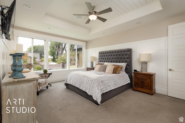 bedroom featuring a tray ceiling, carpet flooring, and recessed lighting
