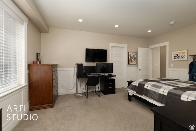 bedroom featuring light colored carpet, a wainscoted wall, recessed lighting, and a desk