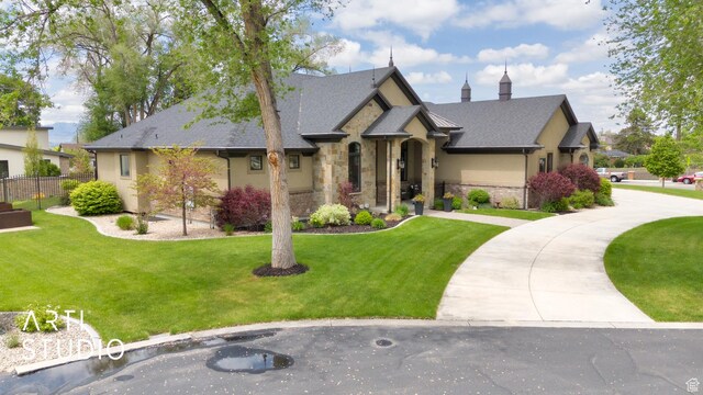 view of front facade featuring stone siding and stucco siding