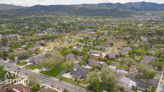 aerial view of property's location with mountains and nearby suburban area
