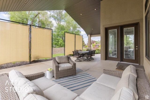 view of patio featuring outdoor lounge area, outdoor dining space, and fence