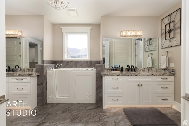 full bath with a bath, two vanities, and tile walls