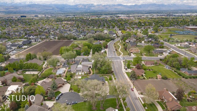 aerial view of property's location with a mountainous background and nearby suburban area