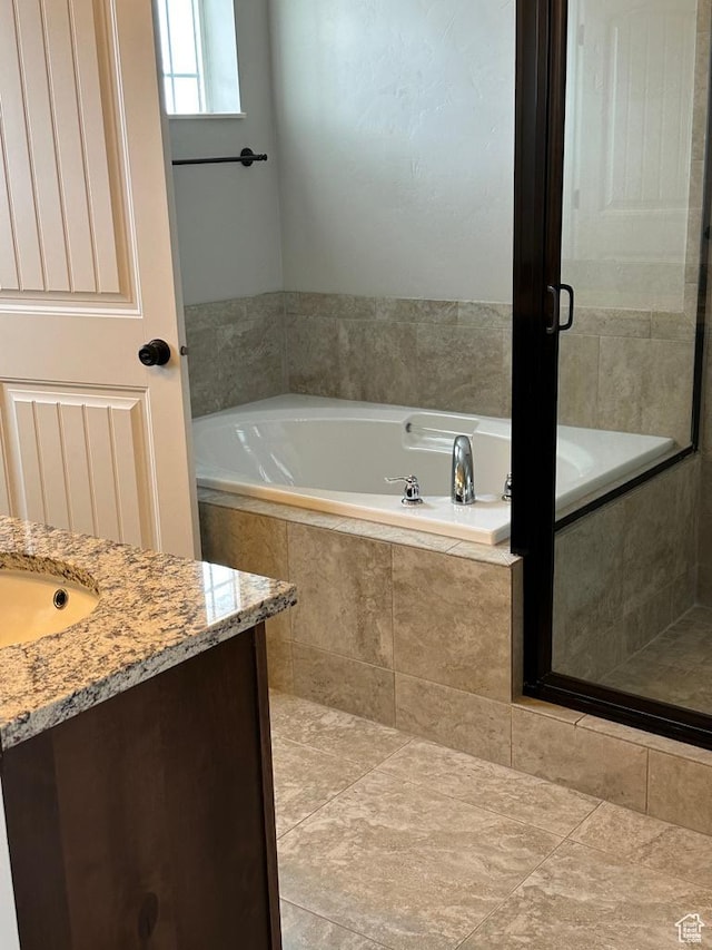 full bath with a garden tub and vanity