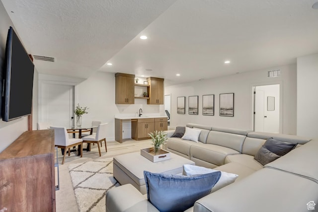 living area featuring recessed lighting and light wood-type flooring