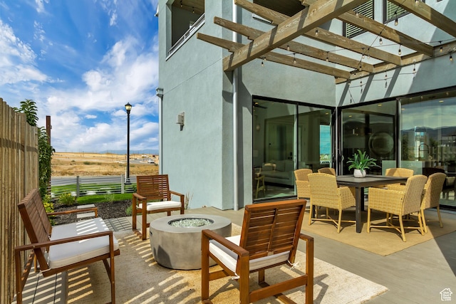 view of patio with an outdoor fire pit, a pergola, and outdoor dining space