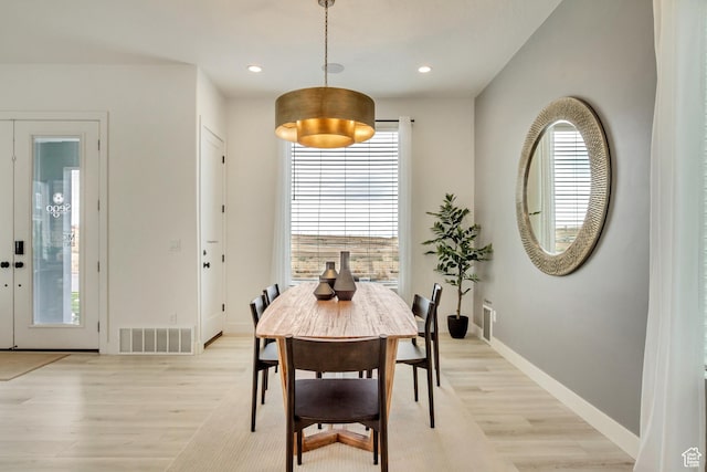 dining room with light wood-style flooring, baseboards, plenty of natural light, and recessed lighting