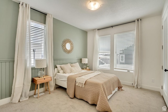 bedroom featuring multiple windows, carpet flooring, and baseboards