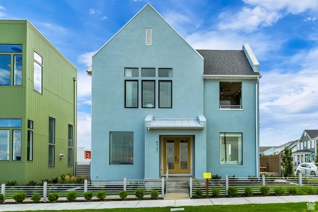 6721 W Lake Ave Unit 121, South Jordan, UT 84009 - view of front of property featuring french doors, a shingled roof, stucco siding, and a fenced front yard