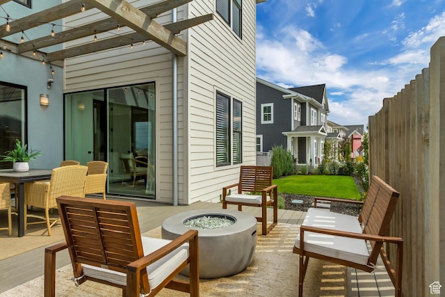 view of patio with a fire pit and a pergola