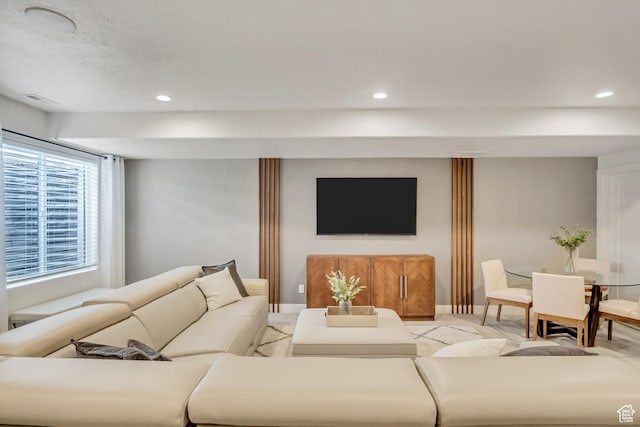 living room with recessed lighting and baseboards