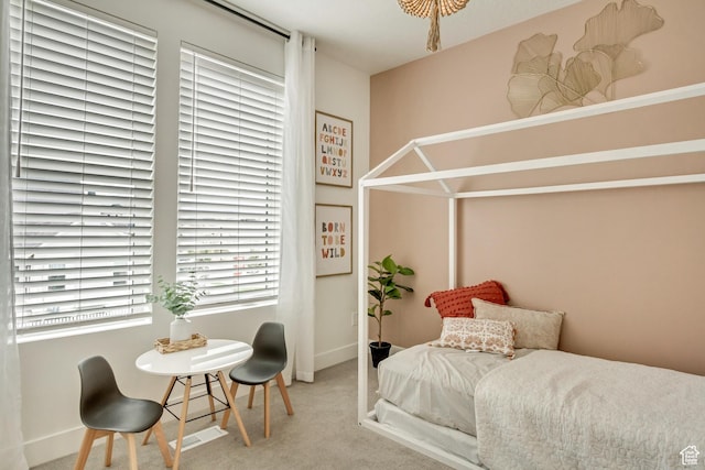 carpeted bedroom featuring baseboards