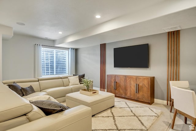 living area with baseboards, light carpet, and recessed lighting