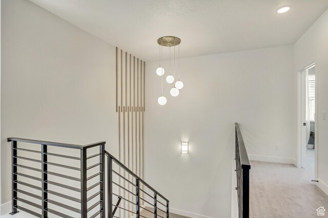staircase with baseboards and carpet flooring