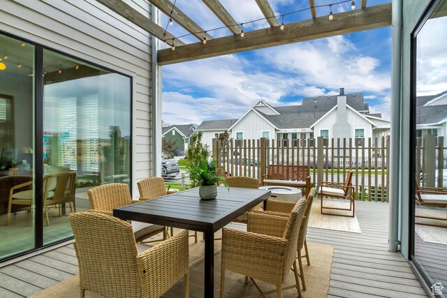 view of wooden balcony with a wooden deck, a residential view, and outdoor dining area