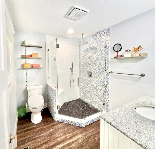 725 W 630 S, Orem, UT 84058 - full bath featuring wood finished floors, toilet, a stall shower, vanity, and a textured ceiling