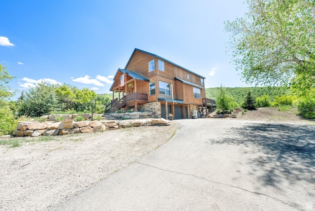 9048 E Acorn Way Unit 984, Heber City, UT 84032 - rustic home with asphalt driveway, stairs, and a garage