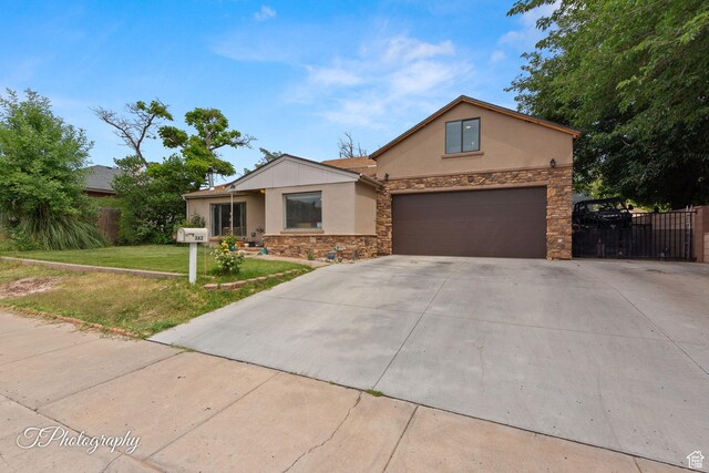 382 W 200 N, St George, UT 84770 - view of front of house featuring stucco siding, stone siding, driveway, and an attached garage