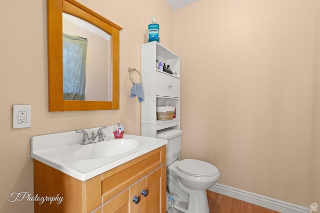 382 W 200 N, St George, UT 84770 - half bath with vanity, toilet, wood finished floors, and baseboards