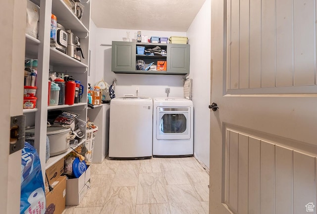 laundry area with independent washer and dryer and light marble finish flooring