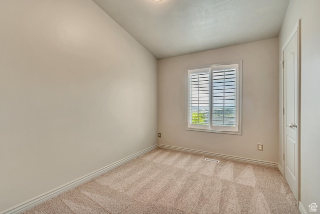 unfurnished room featuring carpet floors and baseboards