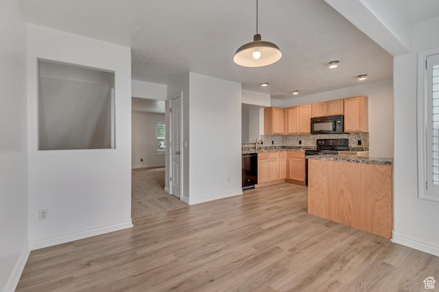 kitchen featuring black appliances, light brown cabinets, light wood-style floors, and tasteful backsplash