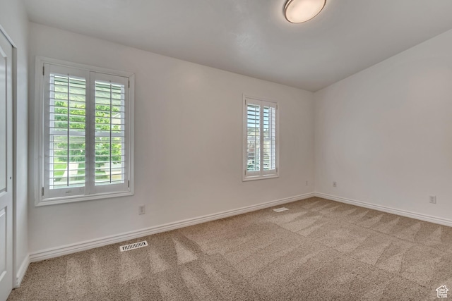 carpeted spare room with baseboards