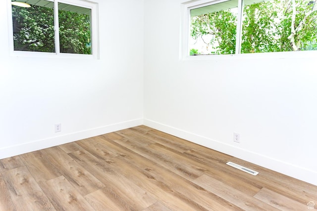 empty room featuring baseboards and wood finished floors