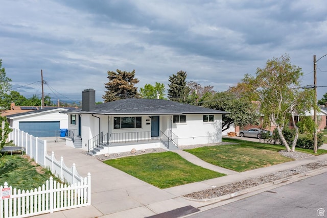 ranch-style home featuring covered porch, a detached garage, a shingled roof, and a chimney