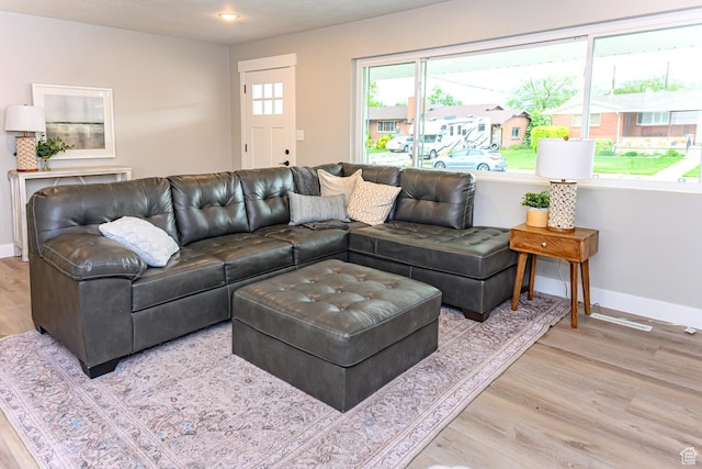 living room featuring baseboards, wood finished floors, and recessed lighting