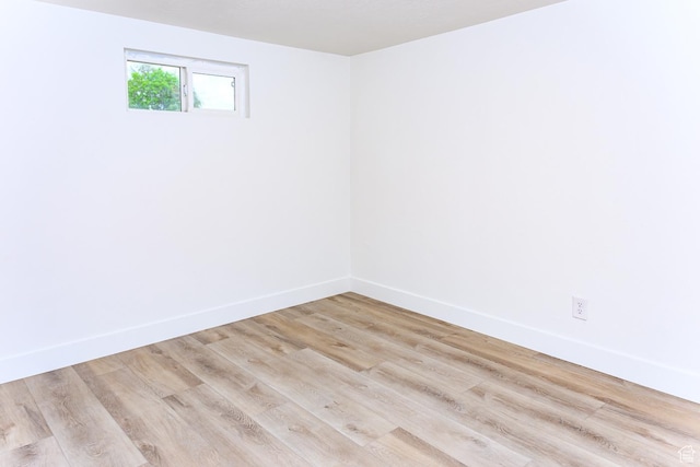 unfurnished room with baseboards and light wood finished floors
