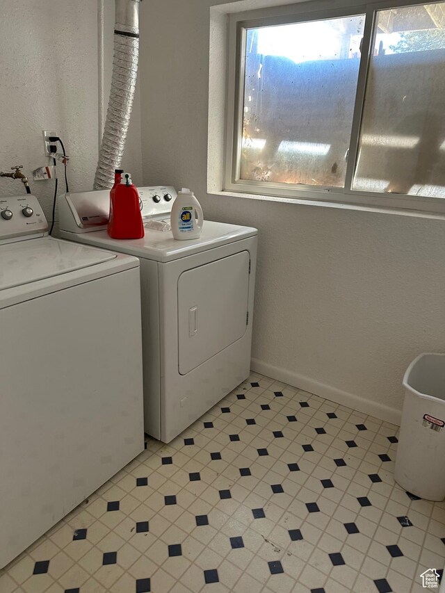 clothes washing area with washing machine and clothes dryer