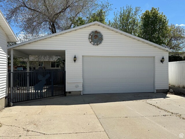 detached garage featuring fence