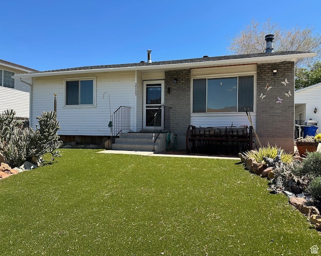 view of front of house featuring a front yard and brick siding